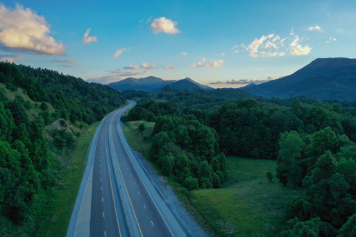 Empty road winding in rolling green hills traveling off into the distance in Tennessee
